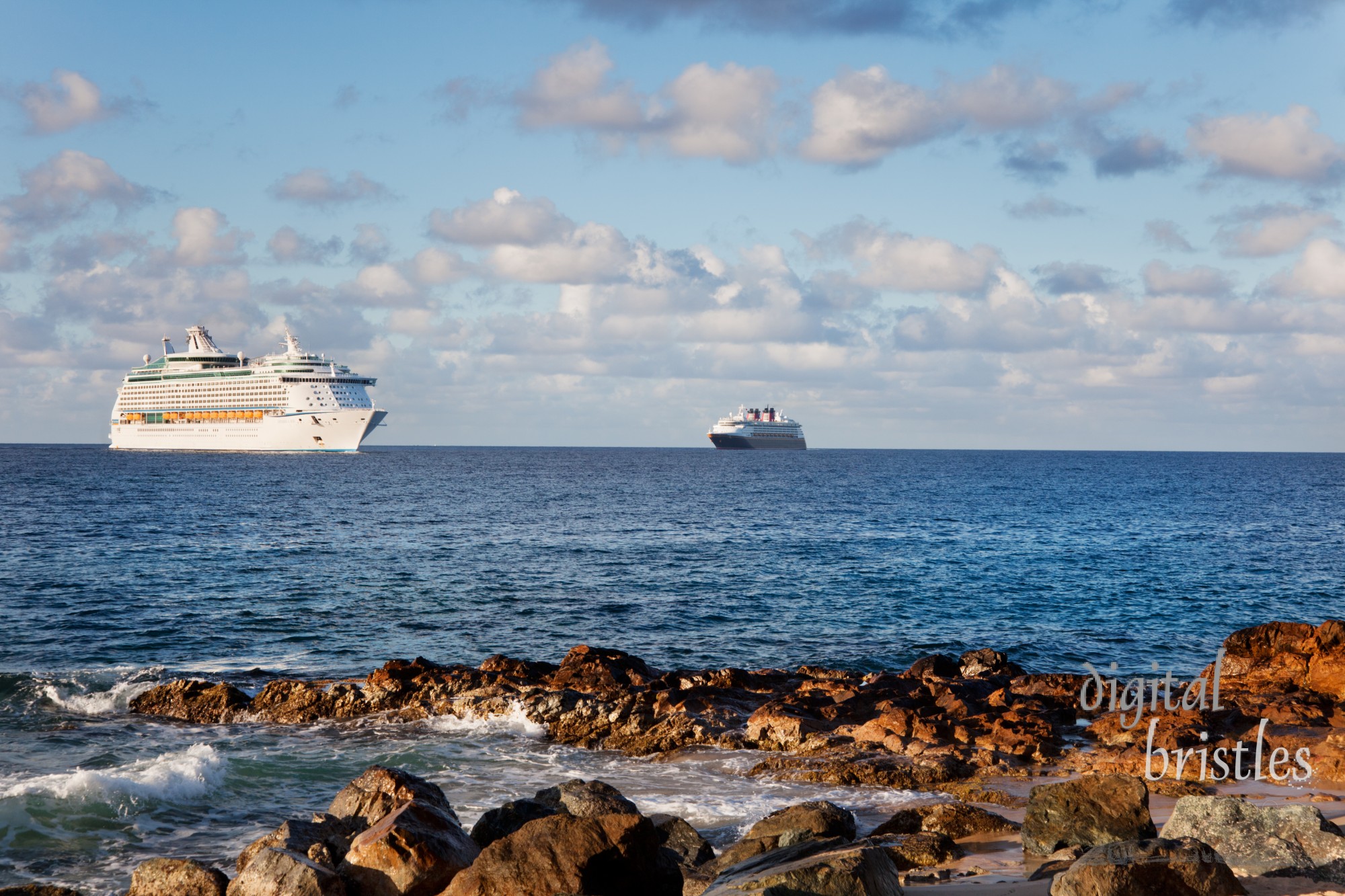 Cruise ships head into port at Charlotte Amalie in St. Thomas in the early morning. Royal Caribbean's Explorer of the Seas is in the foreground with Disney Cruise Lines in the background. Taken from Morningstar Beach.