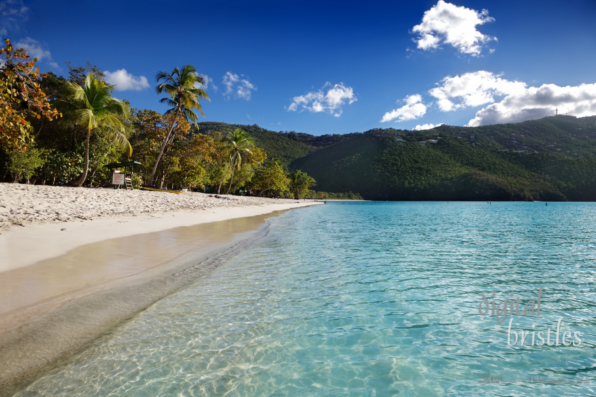 Water laps gently on the beach at Magens Bay in the late afternoon as most visitors have departed