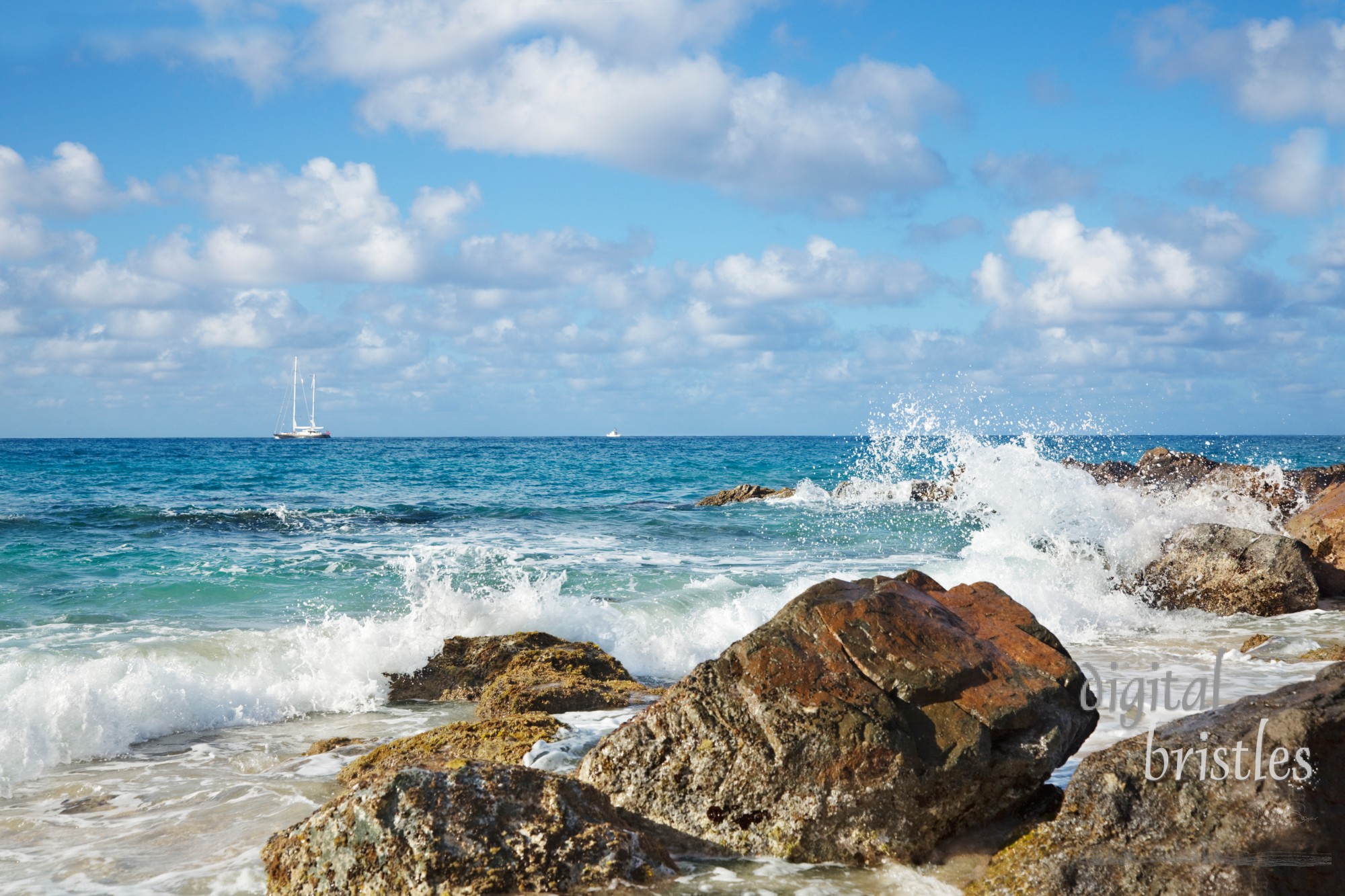 Tropical beach with a sailboat in the distance