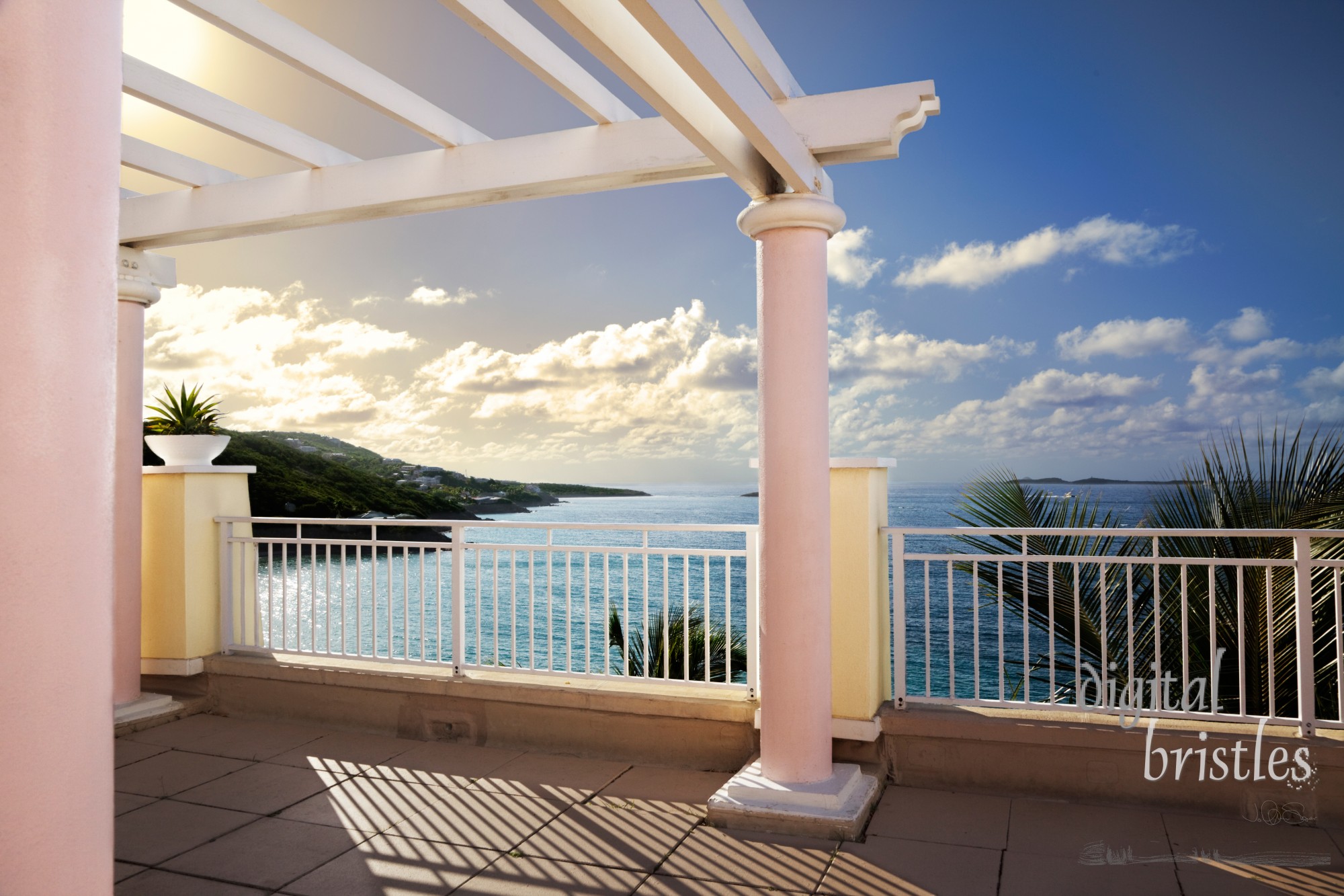 Cliff-top terrace looking out over tropical hills & ocean