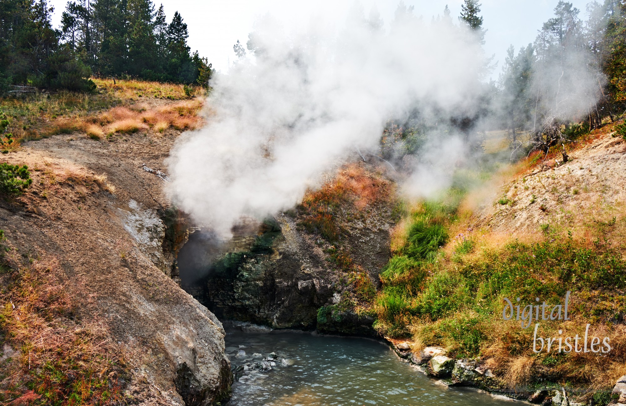 Boiling water of a hot spring has eroded the hillside to create a cavern that belches steam, reminding visitors of a Dragon’s Mouth. Yellowstone National Park, Wyoming