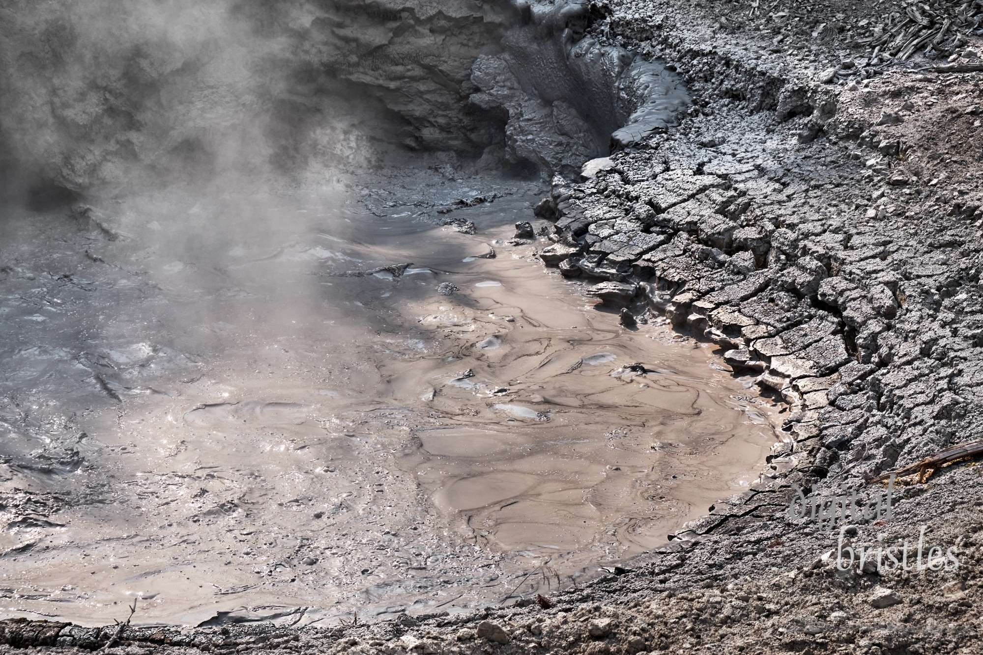 Details of the hot, acidic mud at Yellowstone’s Mud Volcano, bubbling, swirling and gassy.  Yellowstone National Park, Wyoming