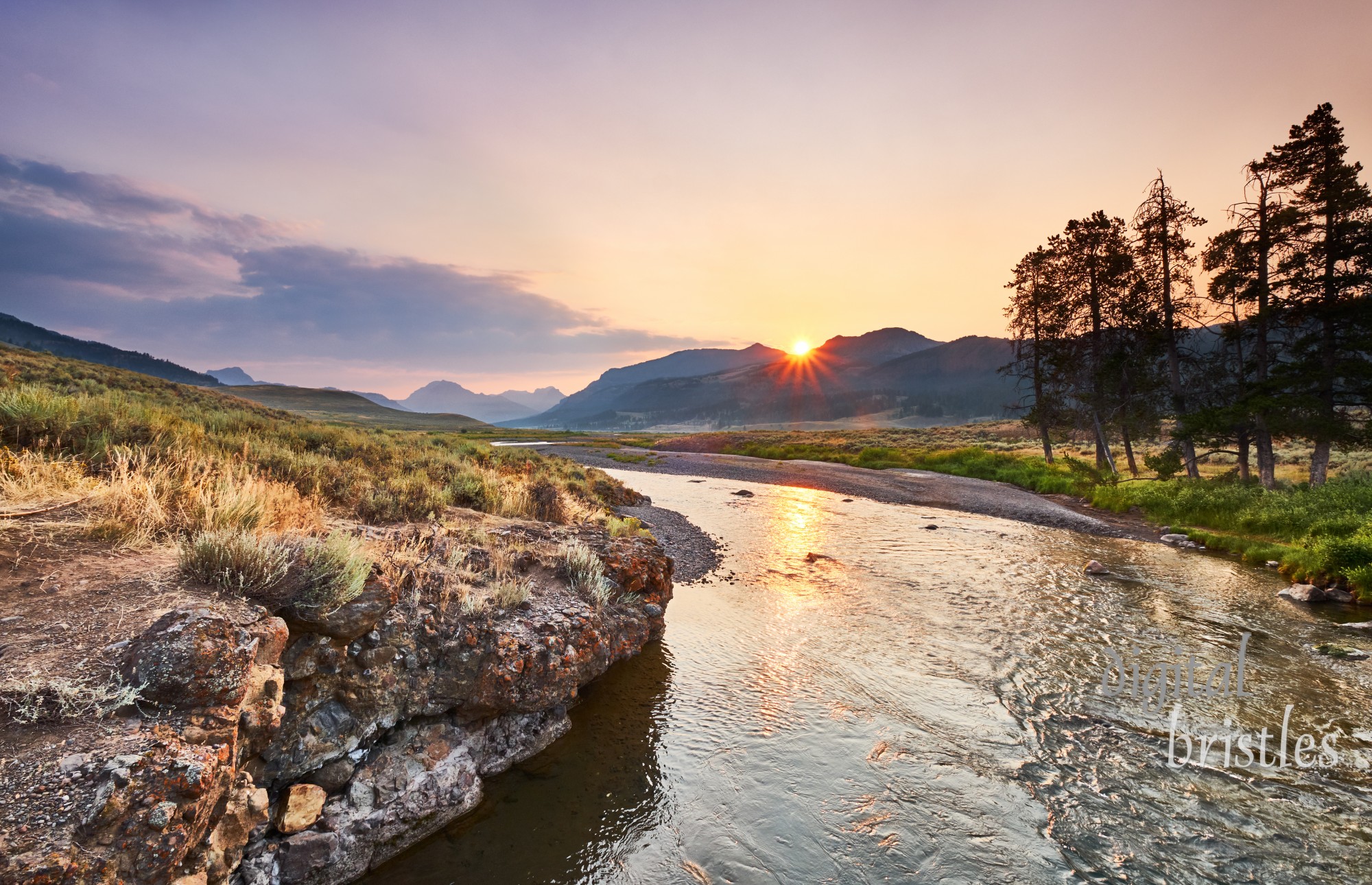 Rocky banks on one side and sagebrush flats on the other bank of Soda Butte Creek