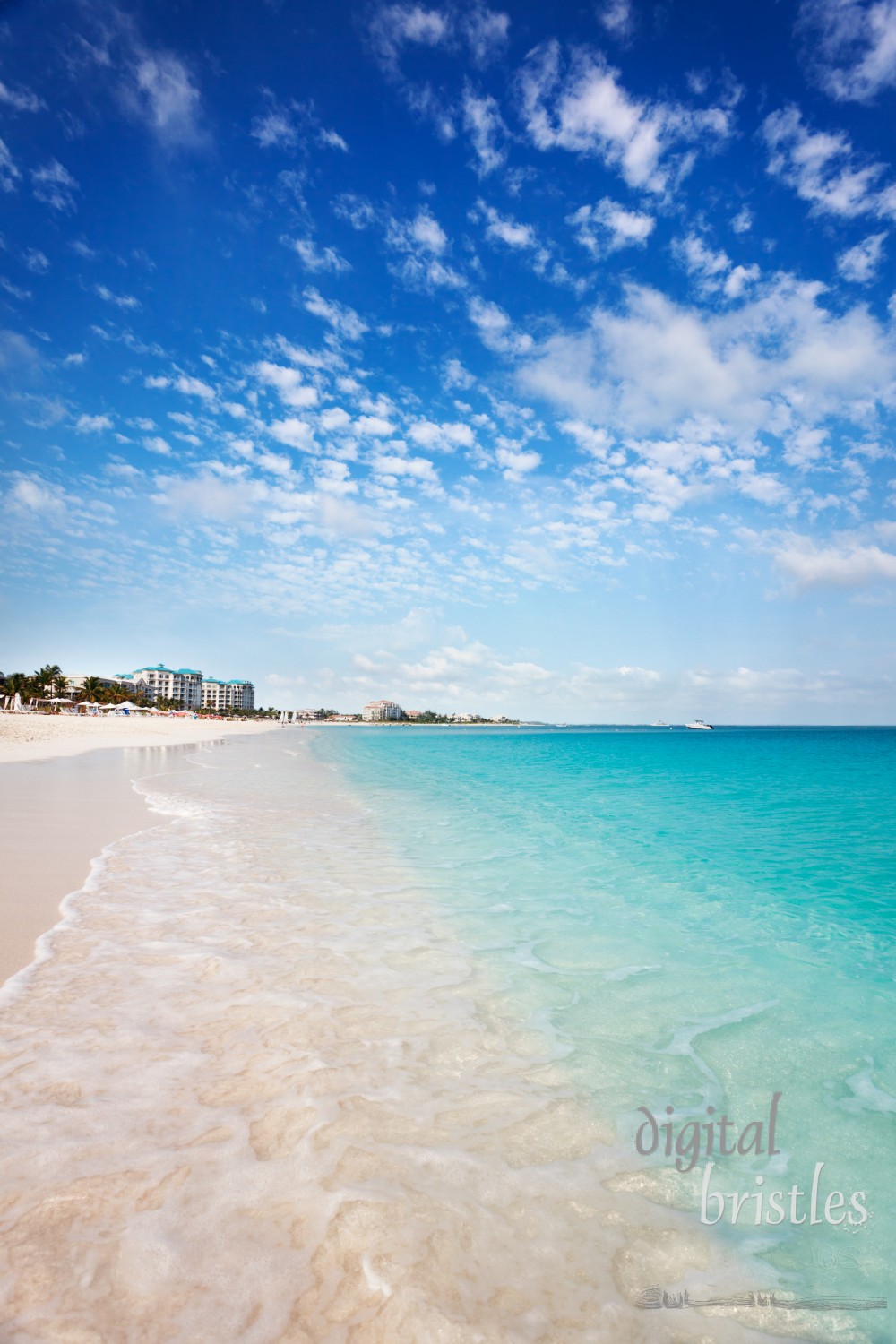 View west down the long white sand Grace Bay Beach, Turks & Caicos