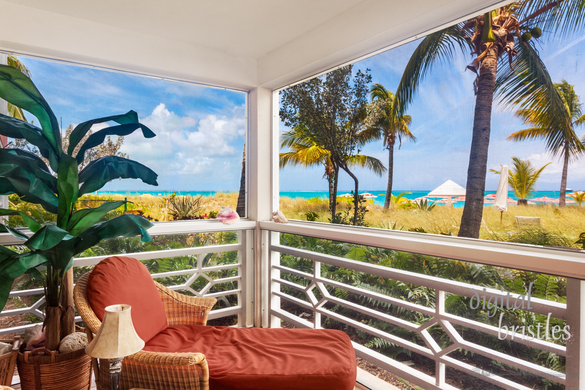 Comfortable chair in the corner of a screened porch overlooking the dunes and Grace Bay Beach, Turks and Caicos