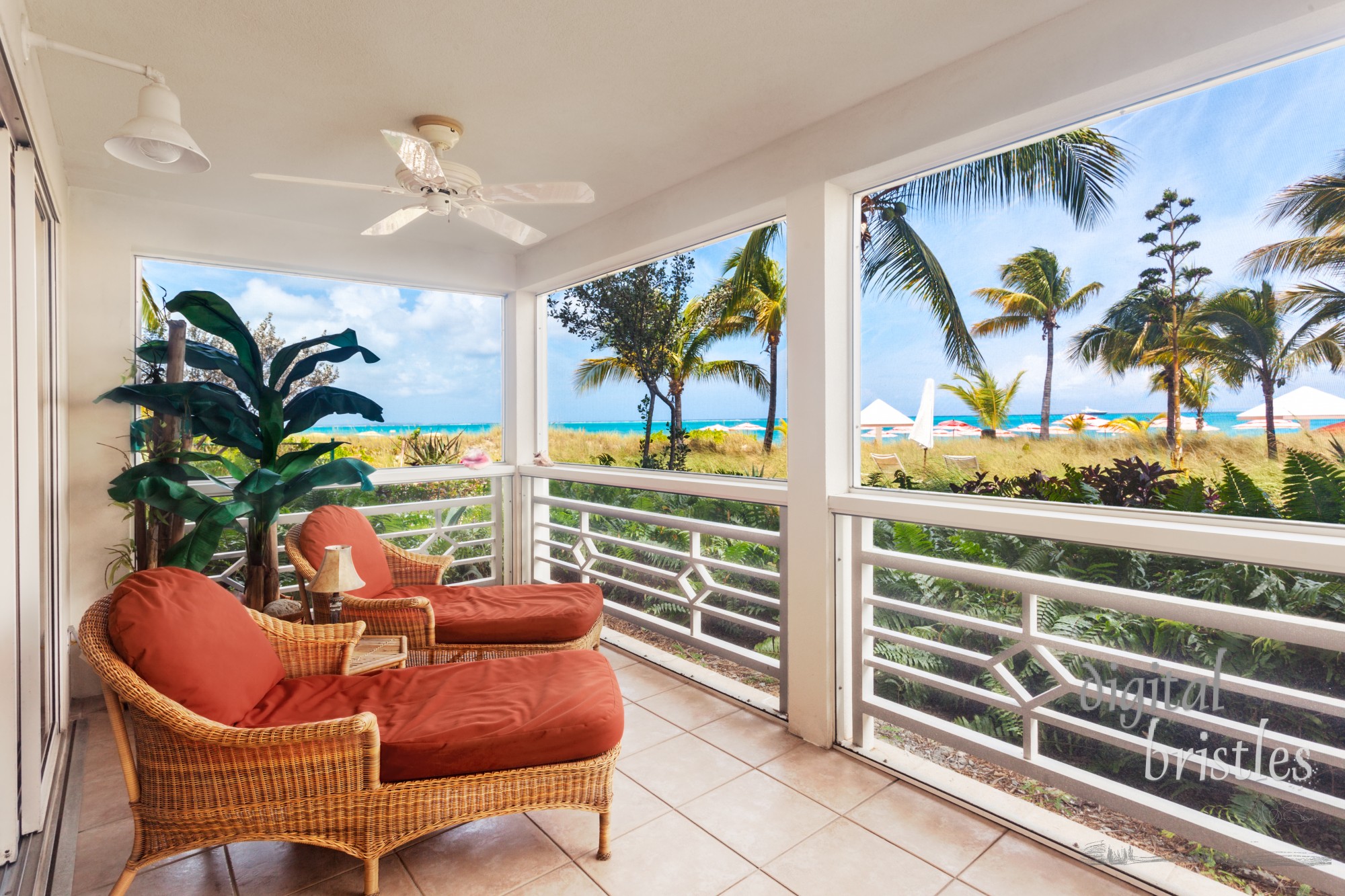 Comfortable chaises in a large screened porch overlook the dunes and Grace Bay Beach, Turks and Caicos