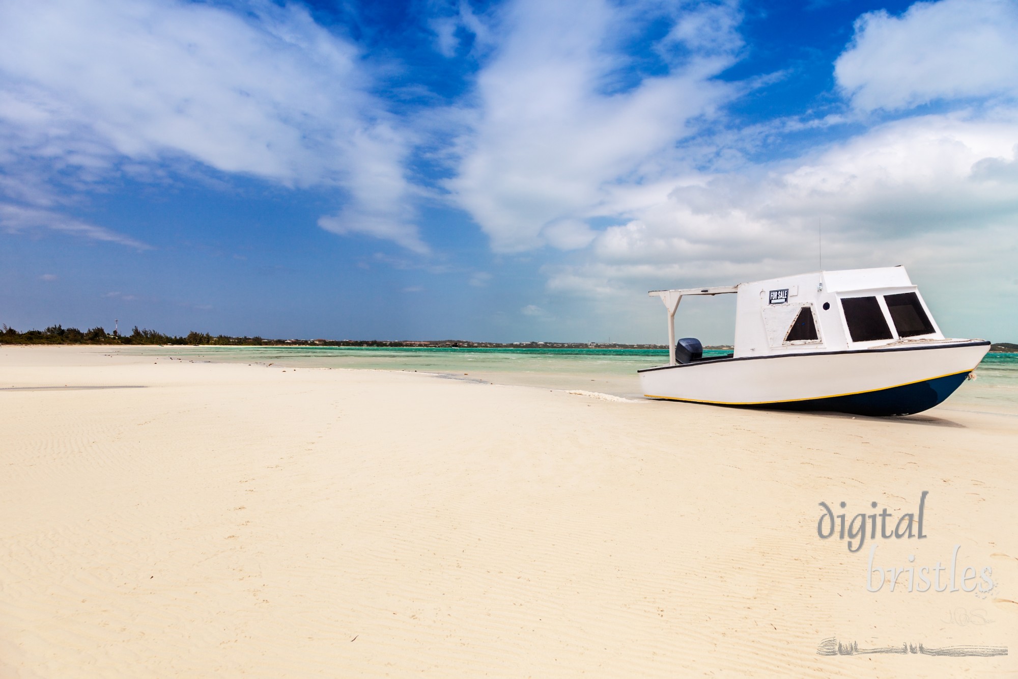 A simple boat beached on a white sand beach, Providenciales, Turks and Caicos