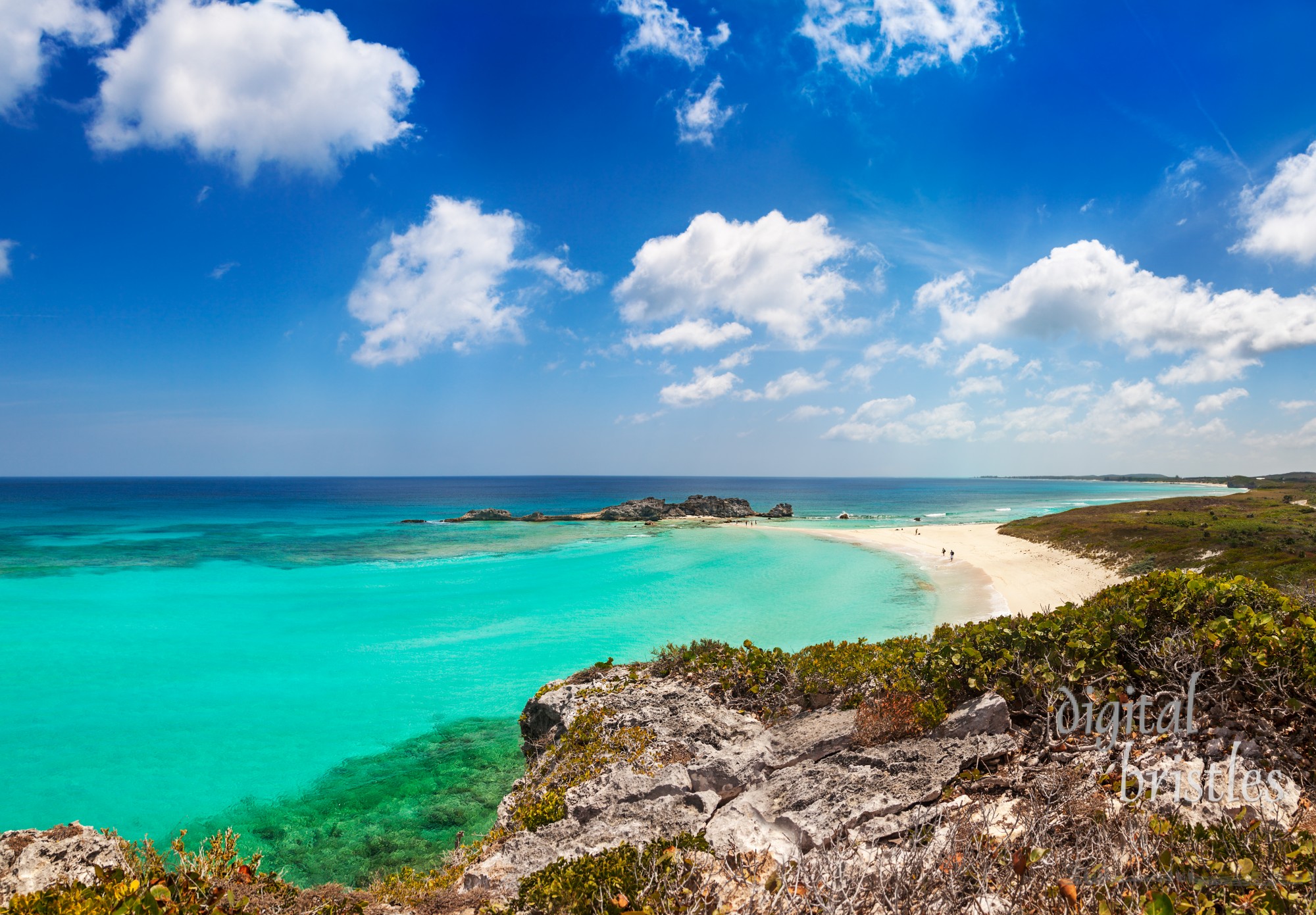 Dragon Cay at low tide viewed from the cliffs above, with the rocks mostly exposed. Mudjin Harbor, Middle Caicos