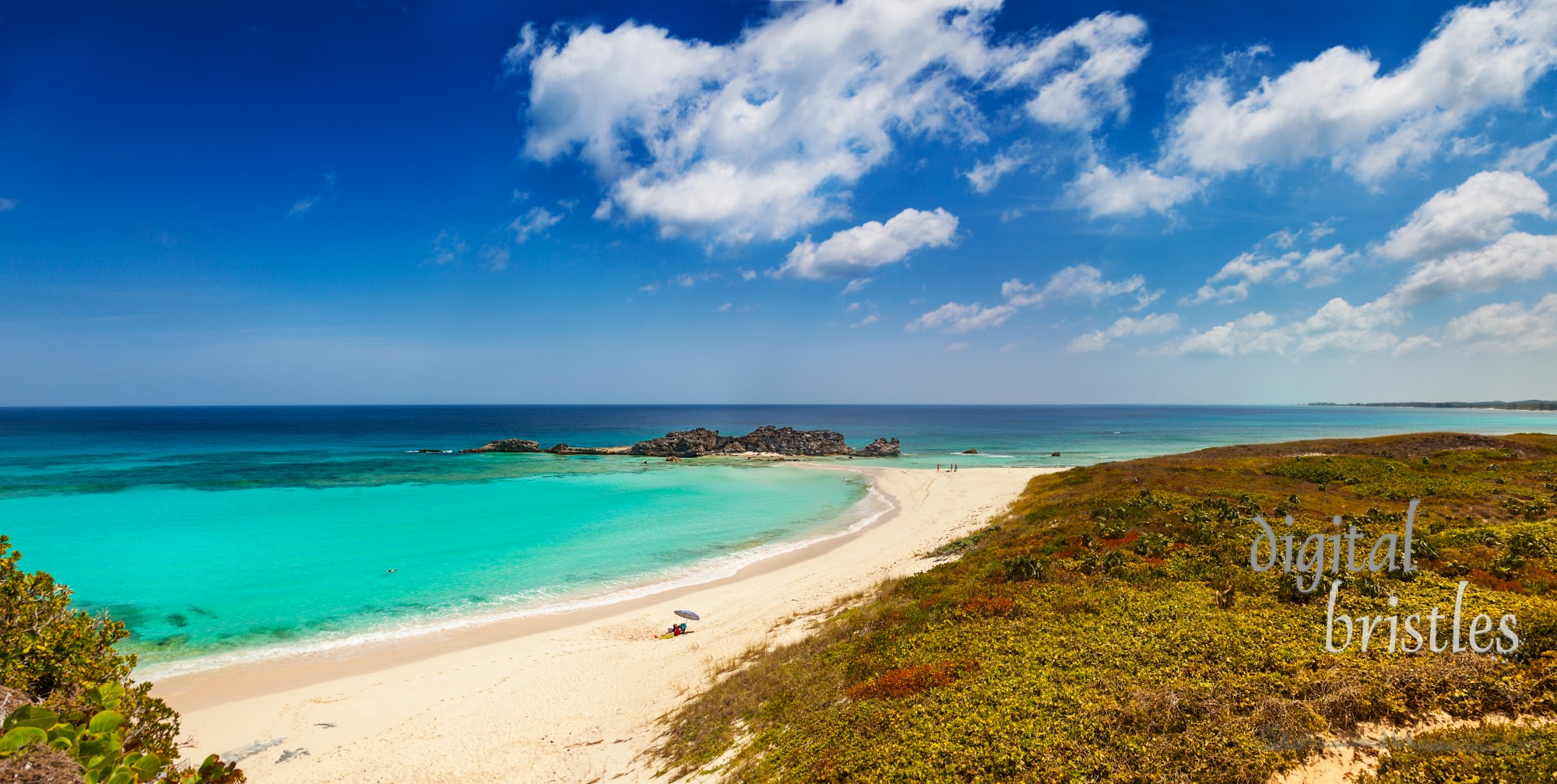 Dragon Cay at low tide, causeway mostly uncovered, and the curving white sand beach viewed from the cliffs above. Mudjin Harbor, Middle Caicos