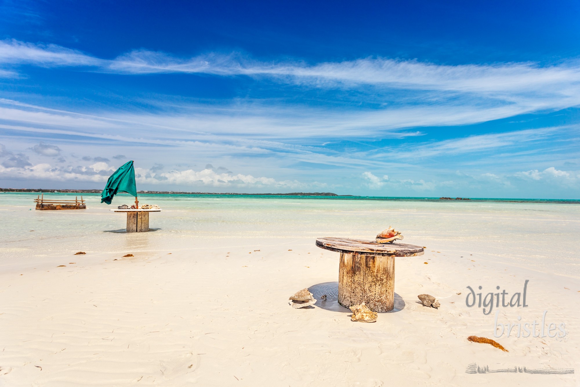 Abandoned cable drum tables on white sand beach near Five Cays, Providenciales, Turks and Caicos