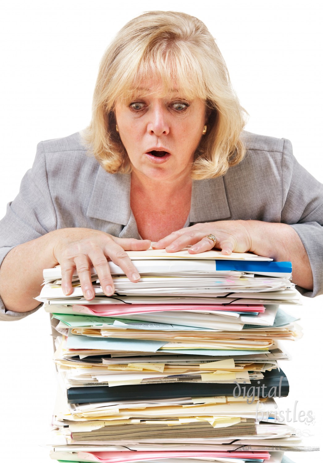 Mature woman trying to stop the pile of work from toppling