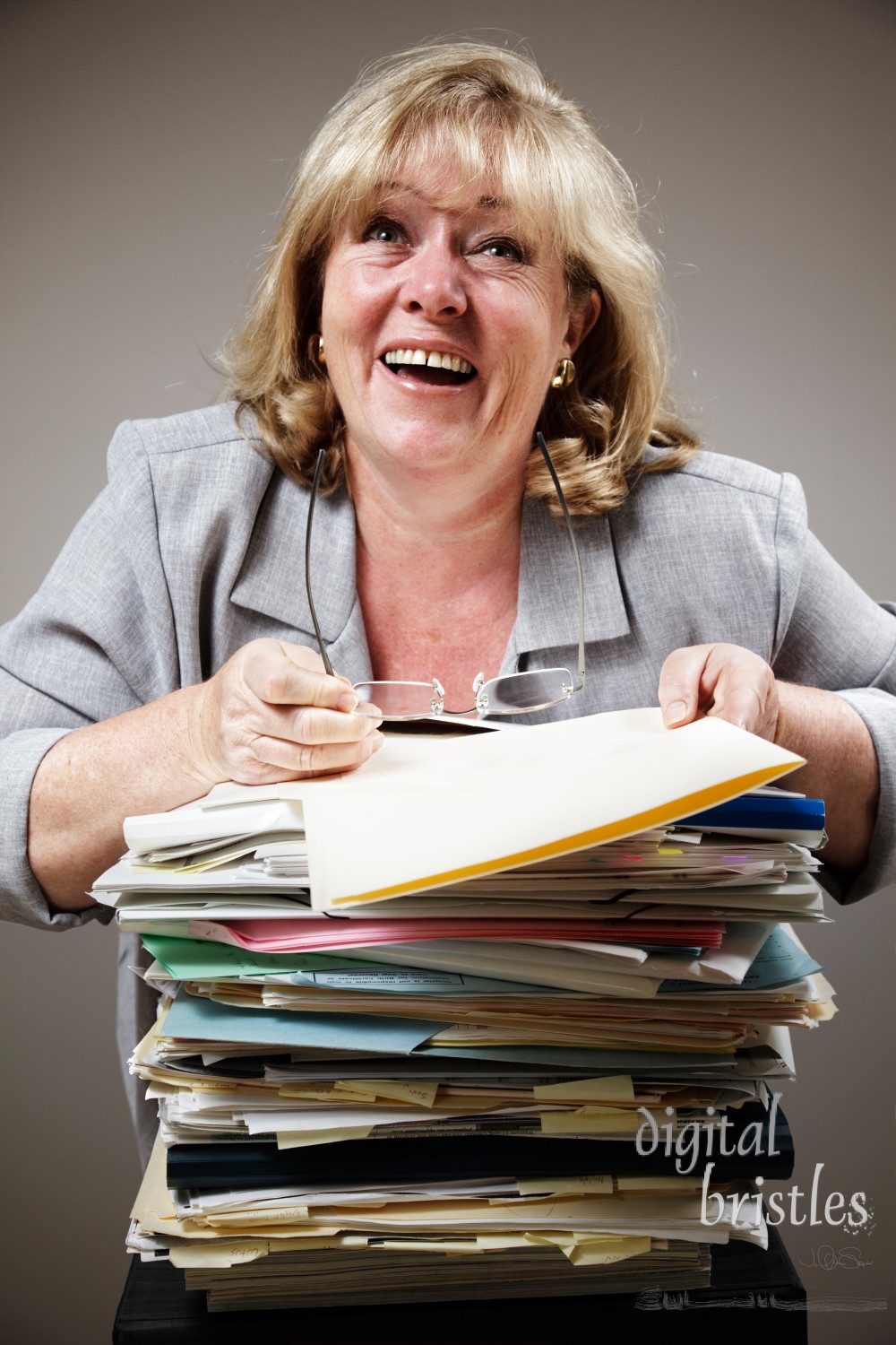 Mature woman losing it in demented laughter as work piles up