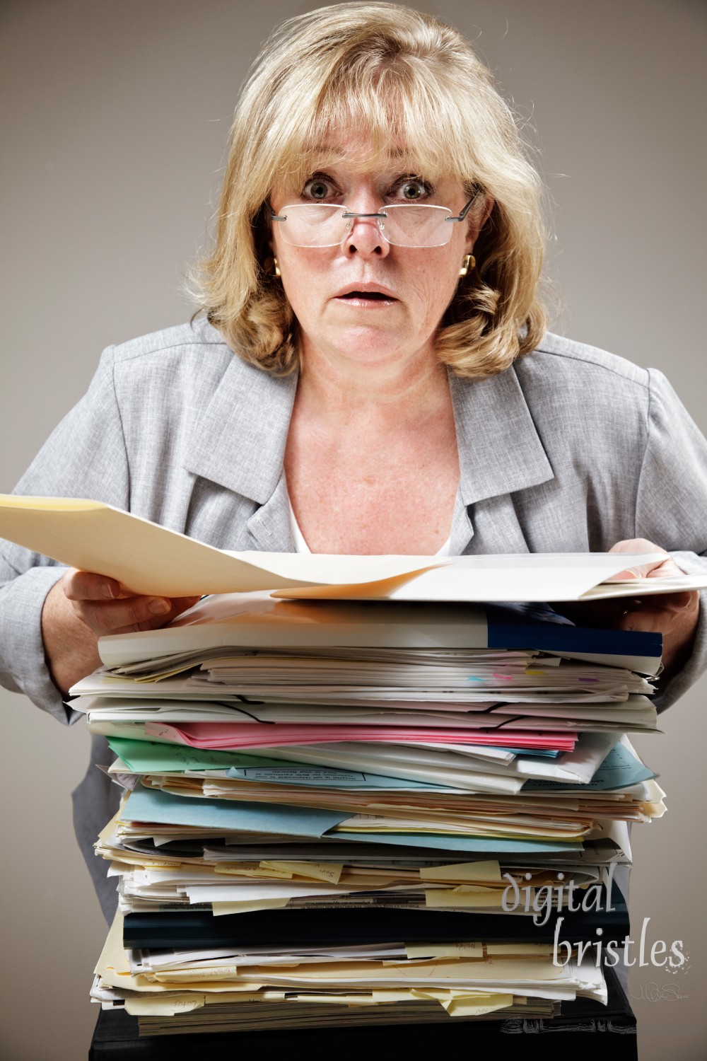 Mature woman overwhelmed by the stack of paperwork